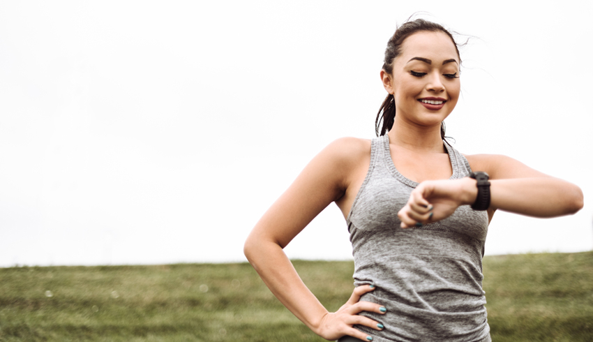 An Asian woman running outside